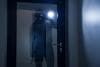Burglar outside a glass door at night